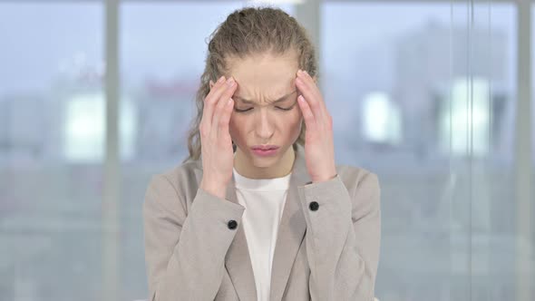 Portrait of Tired Young Businesswoman Having Headache