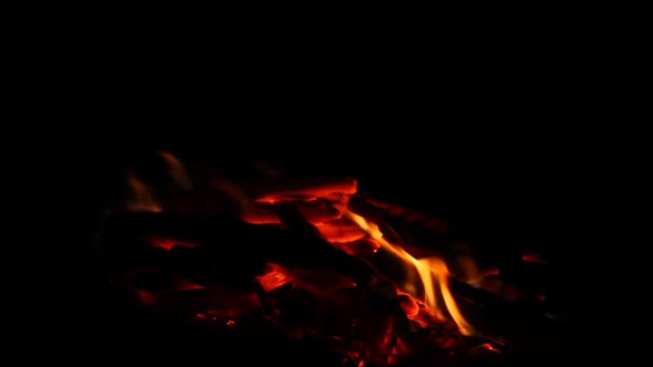 Small Bonfire with Flaming Sparks on a Black Background Closeup