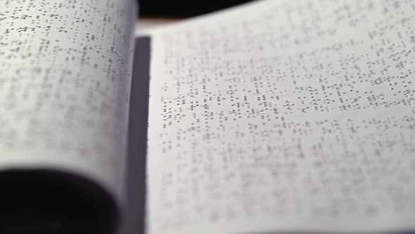 Blind with a Braille Font Turning Pages. Close Up