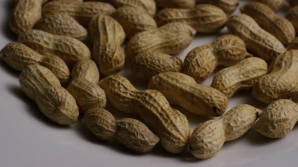 Cinematic, rotating shot of peanuts on a white surface - PEANUTS 009