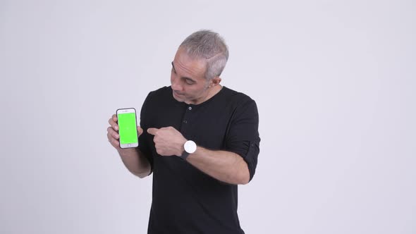 Happy Handsome Persian Man Showing Phone and Giving Thumbs Up