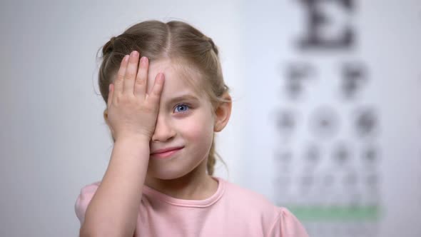 Child Girl Closing Eye, Showing Size or Sign From Eye Chart, Vision Diagnostics