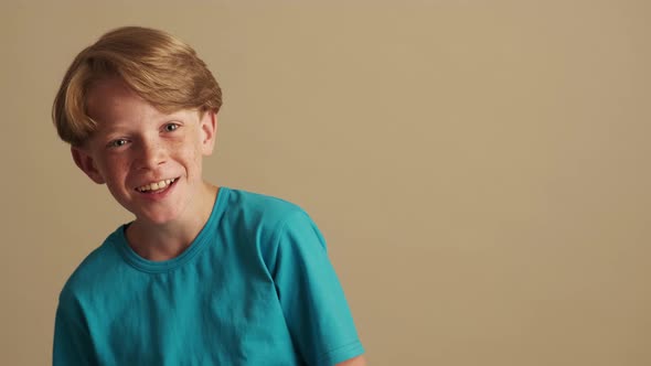 A happy cheerful little boy is looking to the camera