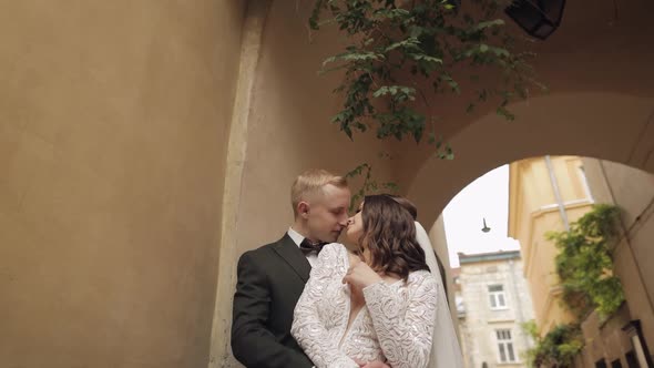 Newlyweds Caucasian Groom with Bride Walking Embracing Hugs in City Wedding Couple in Love