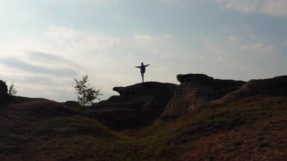 A Girl Does Sports at Sunset on the Shore of the Lake