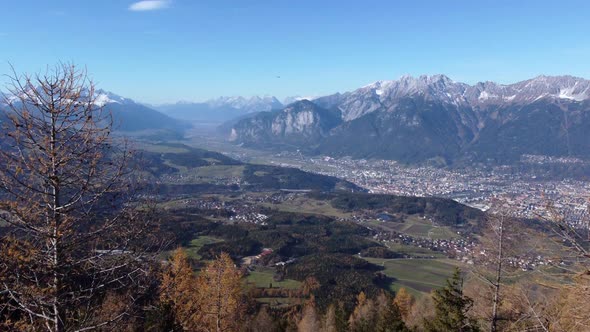 Aerial Reveal of Mountain Valley, Drone Flying Through Trees. Sunny.