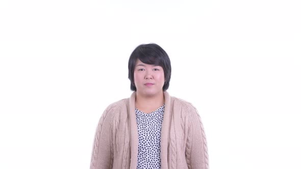 Face of Happy Overweight Asian Woman Looking Surprised Ready for Winter