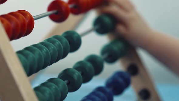 Child Plays with a Multicolored Toy