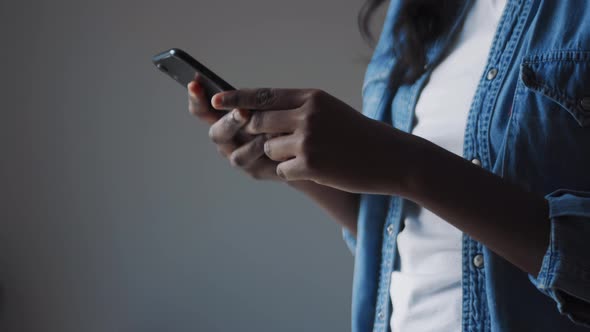 Female hands texting by phone