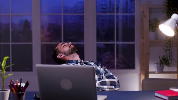 Tired Businessman Sleeping on Chair in His Home Office