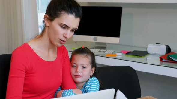 Mother and daughter using laptop 4k