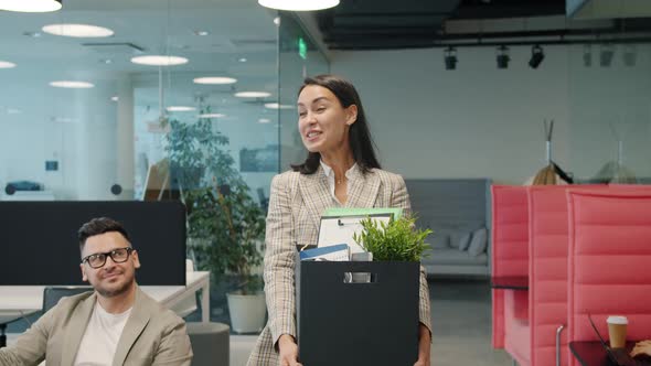 Happy Young Lady Former Employee Quitting Job Leaving Office Room with Box of Things