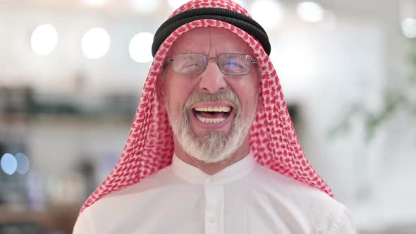 Senior Old Arab Man Feeling Laughing at the Camera