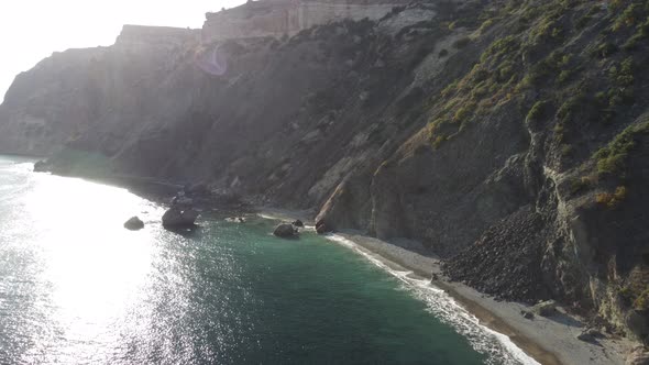 Aerial View From Above on Calm Azure Sea and Volcanic Rocky Shores