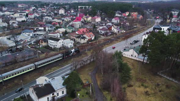 Aerial View of Steam Vintage Locomotive Pass Over the Suburb