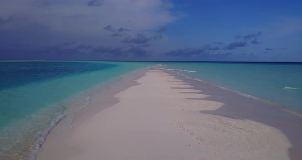 Beautiful drone tourism shot of a white sand paradise beach and blue sea background in high resoluti