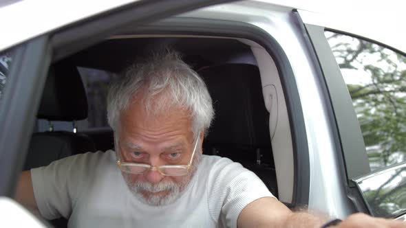 Inadequate Pensioner Man in Glasses Opens Automobile Door
