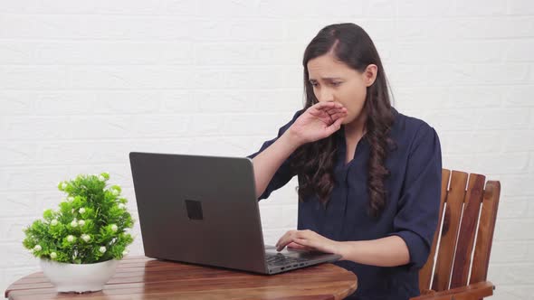 Lazy Indian girl working on a laptop