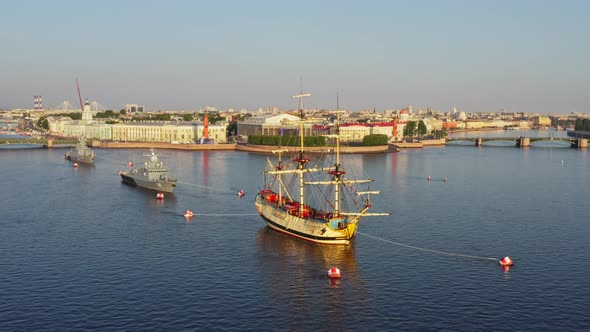 Aerial Morning Urban Landscape with a Replica of the Ancient Frigate Poltava and Modern Cruisers