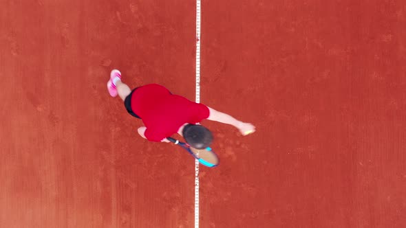 Top View of a Tennis Court with a Man Serving a Ball