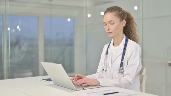 Serious Young Female Doctor Saying No By Finger in Office