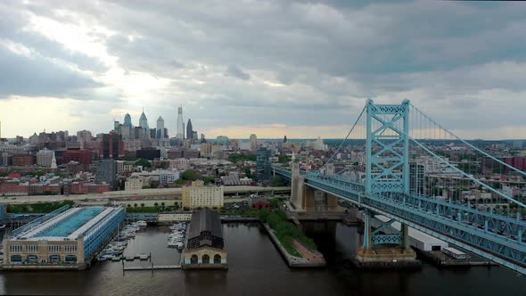 Aerial Drone flying over the Delaware River to show the Ben Franklin Bridge and the Philadelphia sky