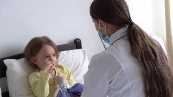 Authentic Cute Caucasian Cute Young Woman Nurse or Doctor Pediatrician Examine with Statoscope Minor