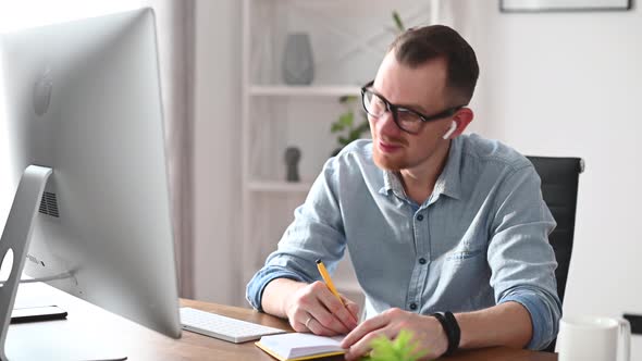 A Young Man Is Working with a PC in the Office