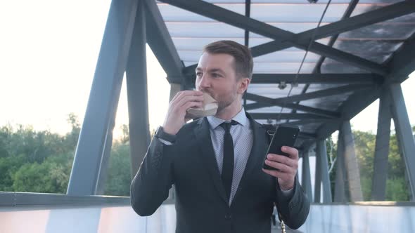 Young Hungry Office Manager in Business Attire Eating a Tasty Hamburger on the Way to Work