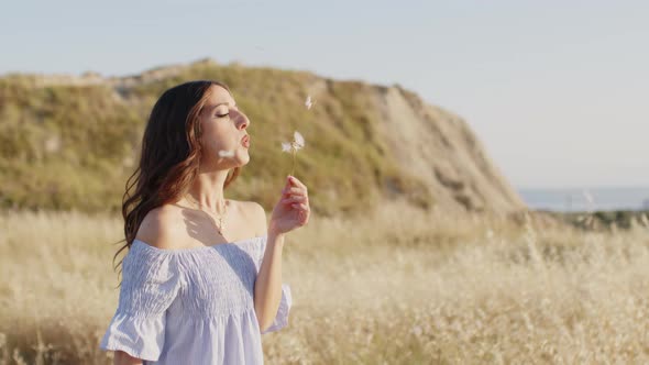 Dandelion Plants in the Countryside with Girl Relaxing in Nature