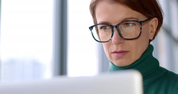 Portrait of an attractive woman working on a laptop.