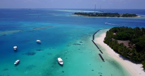 Daytime above tourism shot of a sunshine white sandy paradise beach and aqua blue water background i