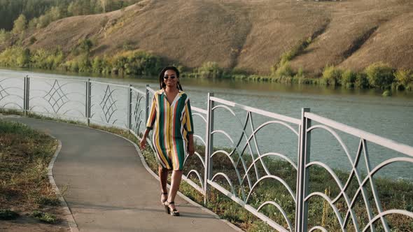 Young African American Woman Spinning with Open Arms in the Center of a City