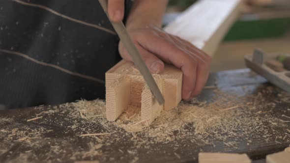 Close up of a carpenter rasping wood