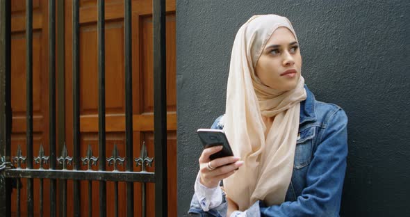 Woman in hijab using mobile phone 4k