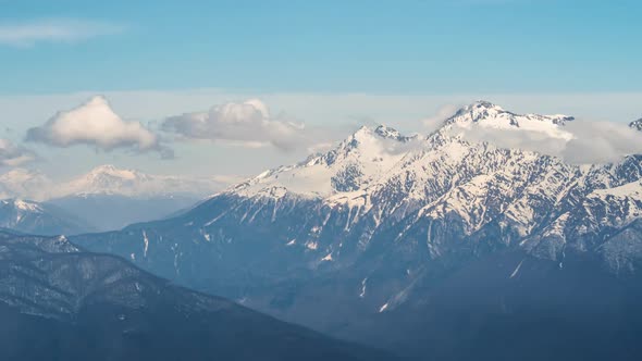 View of clouds passing through winter mountain landscape