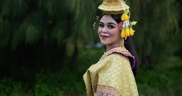 Thai woman in traditional dress looking at camera