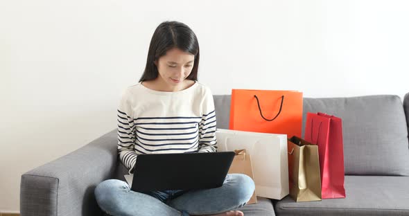 Woman using laptop computer for online shopping