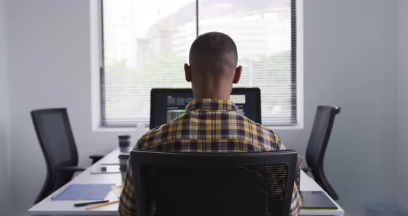 Mixed race man on computer at office