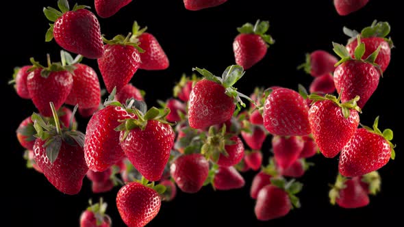 Flying of Strawberry in Black Background