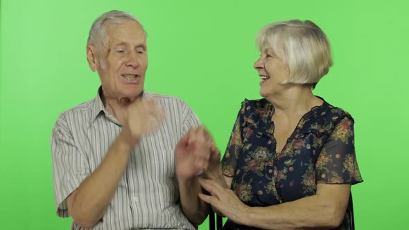 Senior Aged Man and Woman Sitting and Talking Together. Chroma Key Background