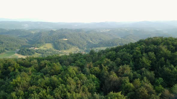 Cinematic aerial shot of an endless mountain and forest landscape in southern Slovenia.