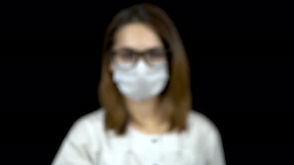 Sperm in a Test Bank Close-up. Woman Doctor Holds Out a Jar of Sperm To the Camera on a Black