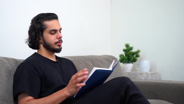 Indian man reading a book peacefully