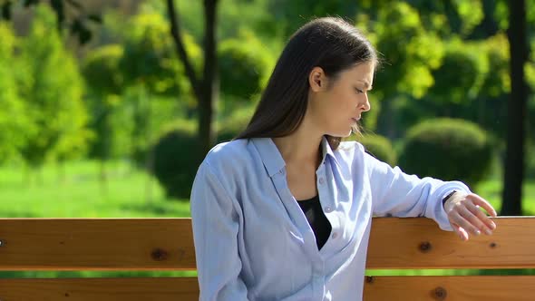 Offended Woman Waiting for Boyfriend, Looking at Wristwatch and Leaving Park