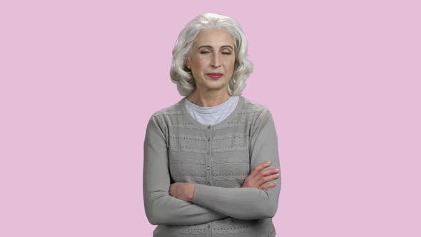 Portrait of Smiling Mature Woman on Pink Background.