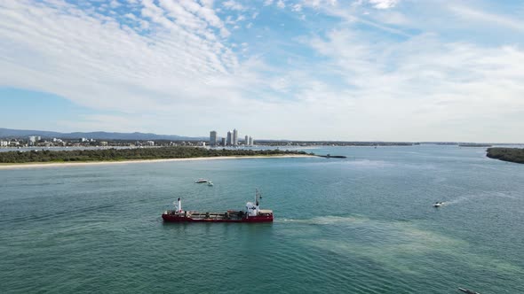 Large ship disrupting a environmentally sensitive marine ecosystem close to a coastal township. High