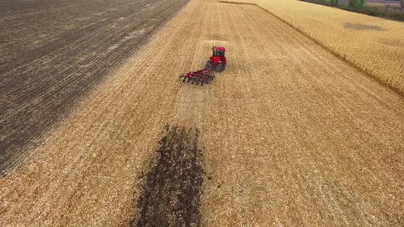 Red Tractor Preparing Land for Sowing, Aerial Shot, Field Corn