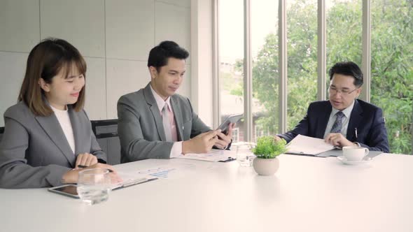 Businessman meeting in workplace with his colleague and signing a contract