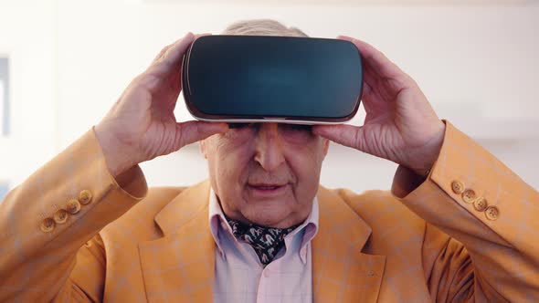 Amazed Senior Using a VR Headset and Experiencing Virtual Reality